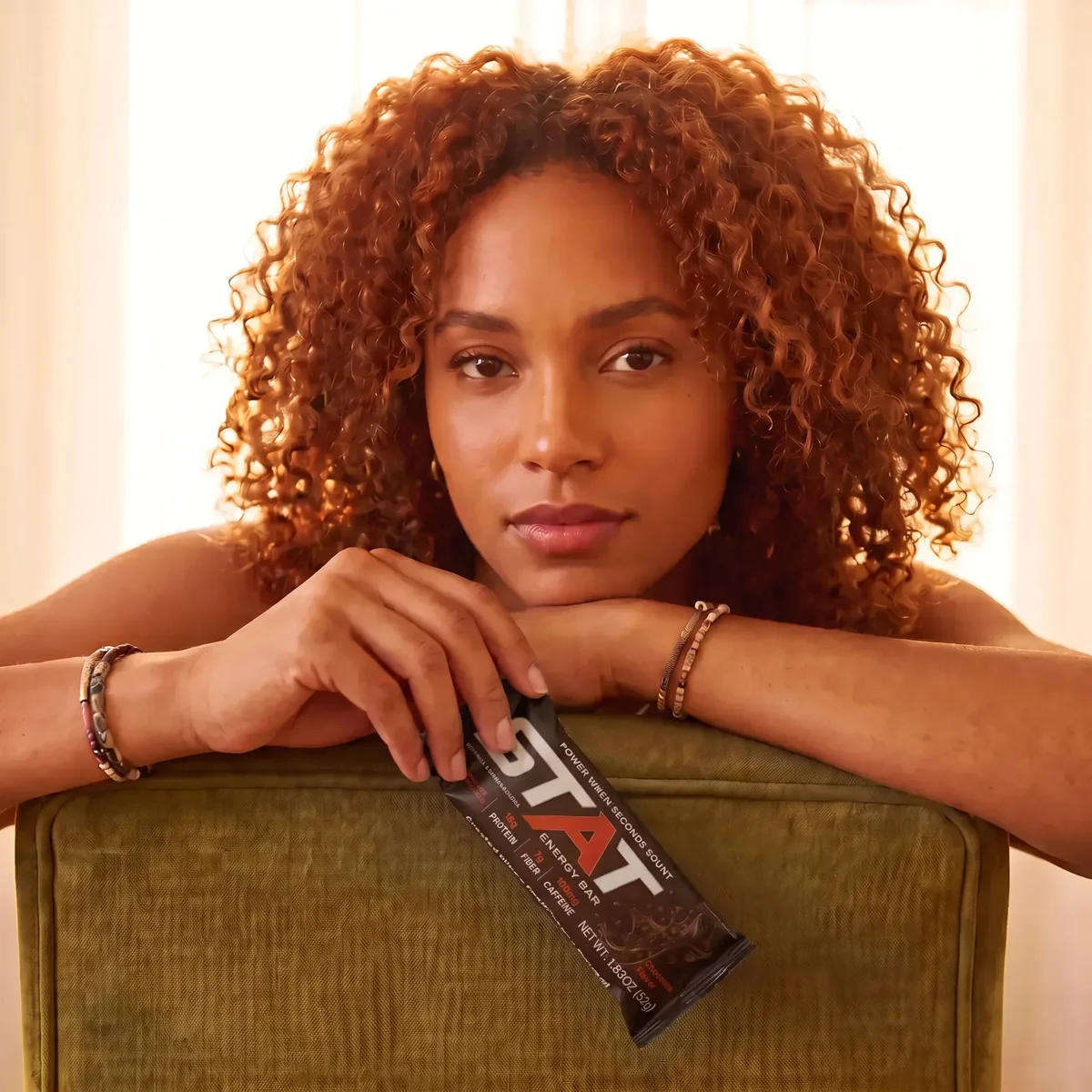 Woman holding a STAT Chocolate bar